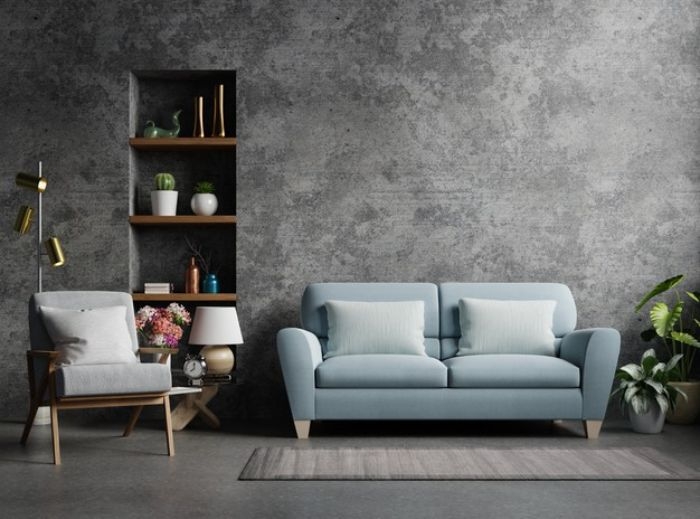 mur de béton canapé bleu fauteuil gris étagère bois et métal sol gris exemple de déco industriel chic