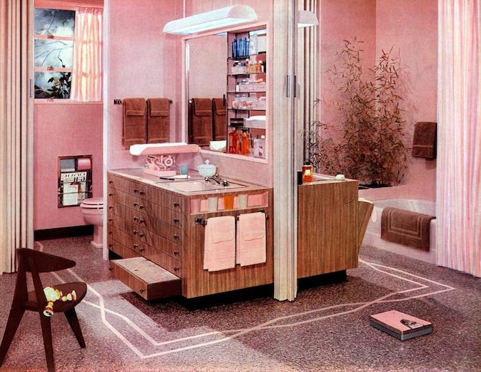 une salle de bain vintage et féminine avec un grand miroir et peinture vieux rose