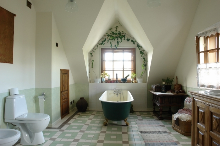 baignoire autoportante vert foncé meuble salle de bain rustique plante bain carrelage vert pastel