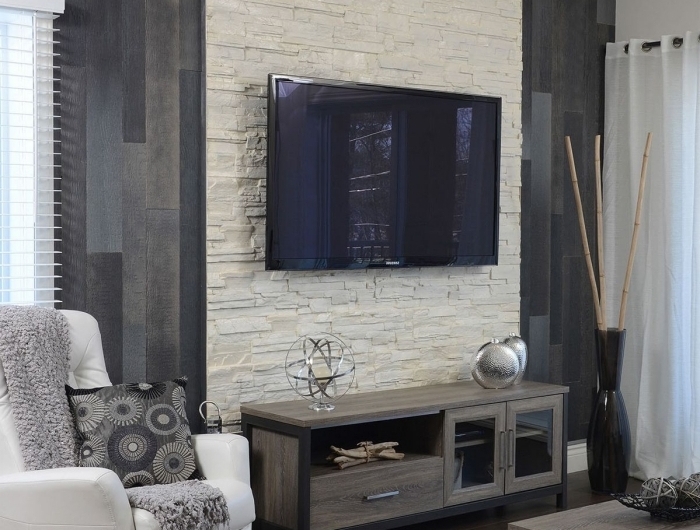 décoration petit salon moderne avec meubles en bois idée mur en pierre salon tv fauteuil blanc