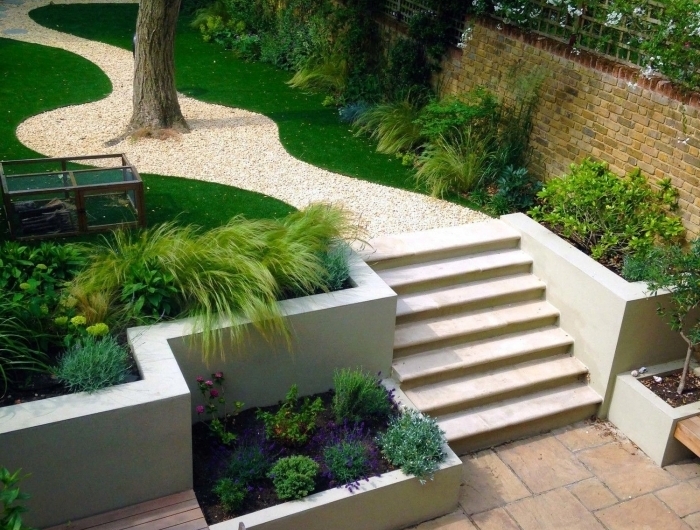 idee jardin paysagiste zen galets blancs plantes vertes terrasse banquette et table en bois foncé