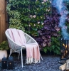 salon de jardin cocooning avec chaises en metale et couverture moelleuses gravier pots fleuris brise vue naturel