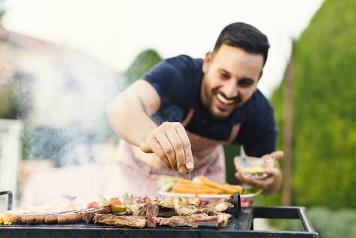 homme aux cheveux noir barbeque en dehors viande