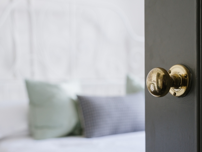 closeup shot of a gold door knob on a black door