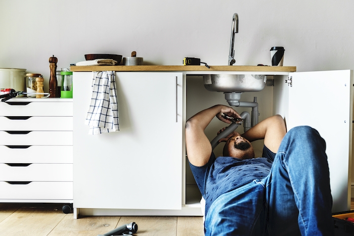 plumber man fixing kitchen sink