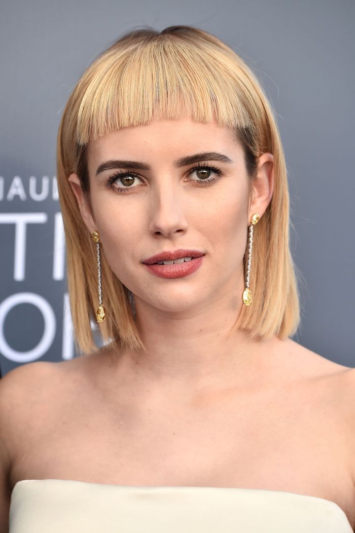 Modern short haircut for a woman with blonde hair and light makeup