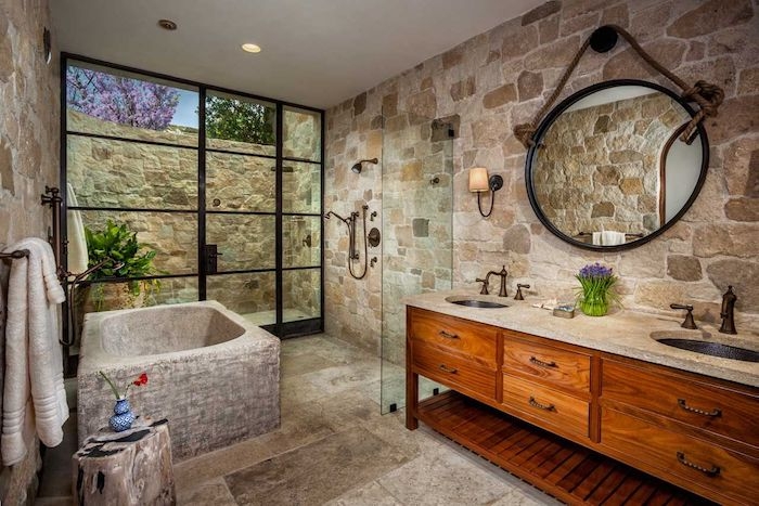 salle de bain travertin et bois baignoire en pierre naturelle cadre de porte fenetre noir miroir noir