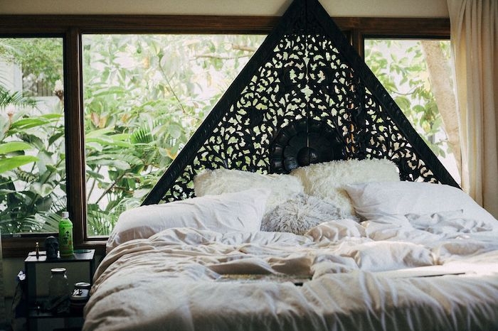 tete de lit originale noire en triangle linge de lit blanc en contraste vegetation