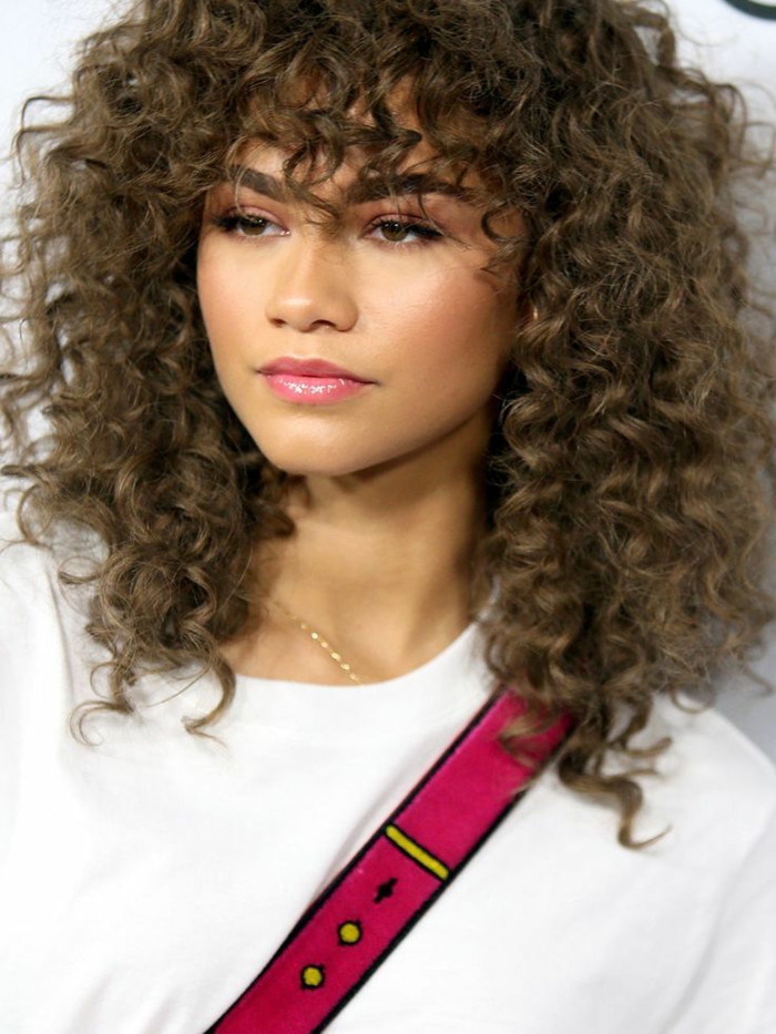 zendaya sinks in a square curly haircut with variable volume curly hair