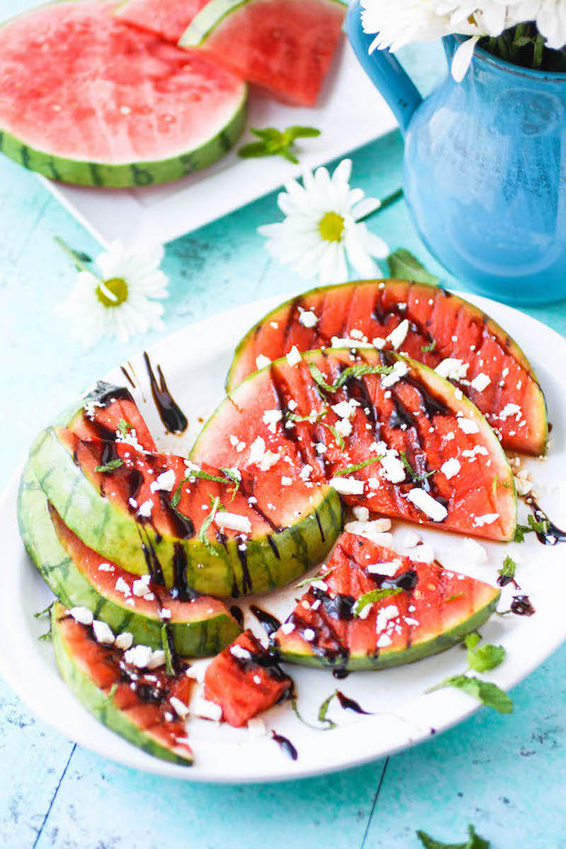 Grilled watermelon recipe on a plate with feta and mint balsamic cuts