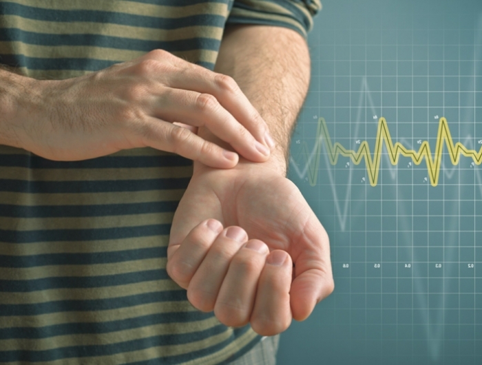 man checking pulse with fingers