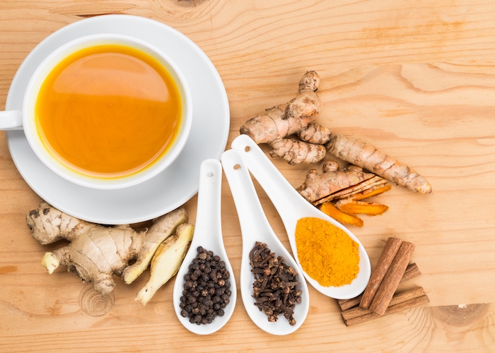 healthy turmeric tea with black pepper, cinnamon, cloves and ginger