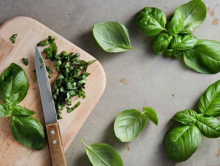 freshly chopped basil leaves. fresh basil on a wooden chopping b