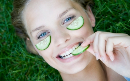 young woman with cucumber mask on face