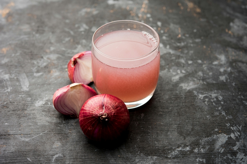 medicinal,onion,juice/syrup,in,a,glass,with,raw,onions.,selective