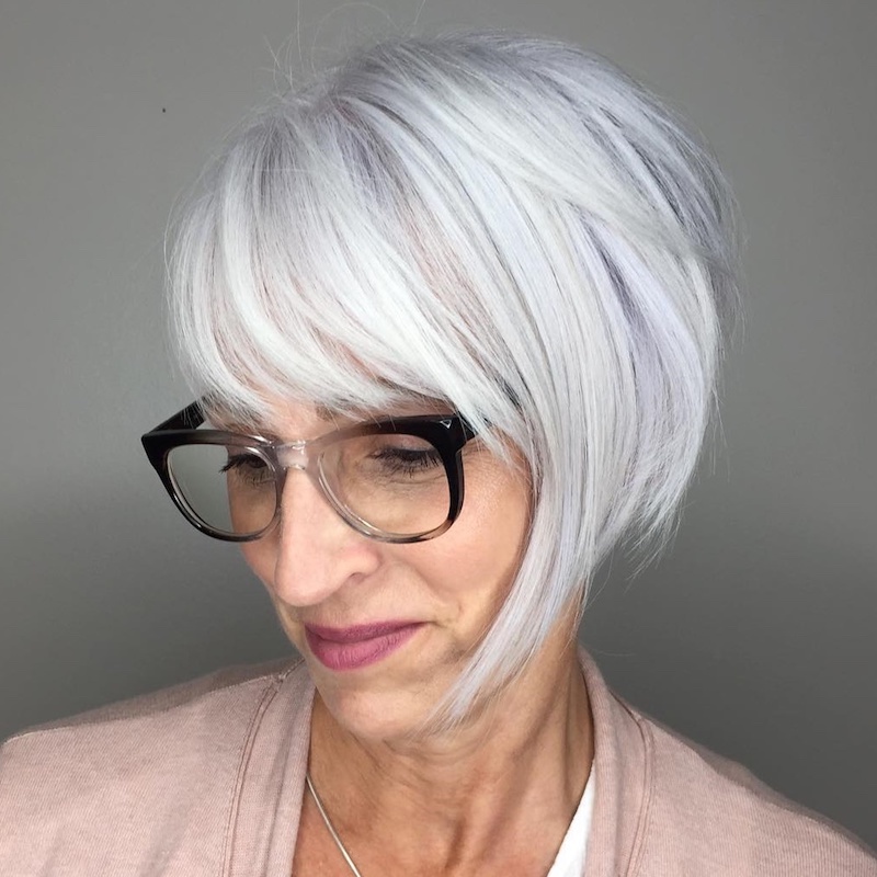 Hairstyle for a 60-year-old woman with the idea of ​​glasses with the longest wick in front of round woolen glasses with blond hair color