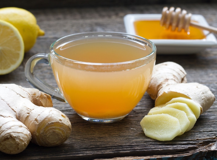 ginger homemade tea infusion on wooden board with lemon
