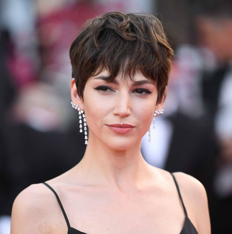 Short, tapered haircut for women 2022 with a fringe woman in an evening dress