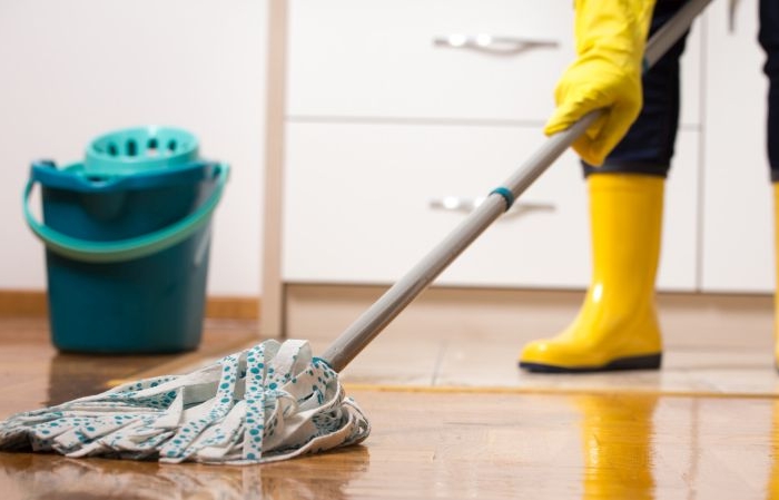 housekeeper mopping tiled floor