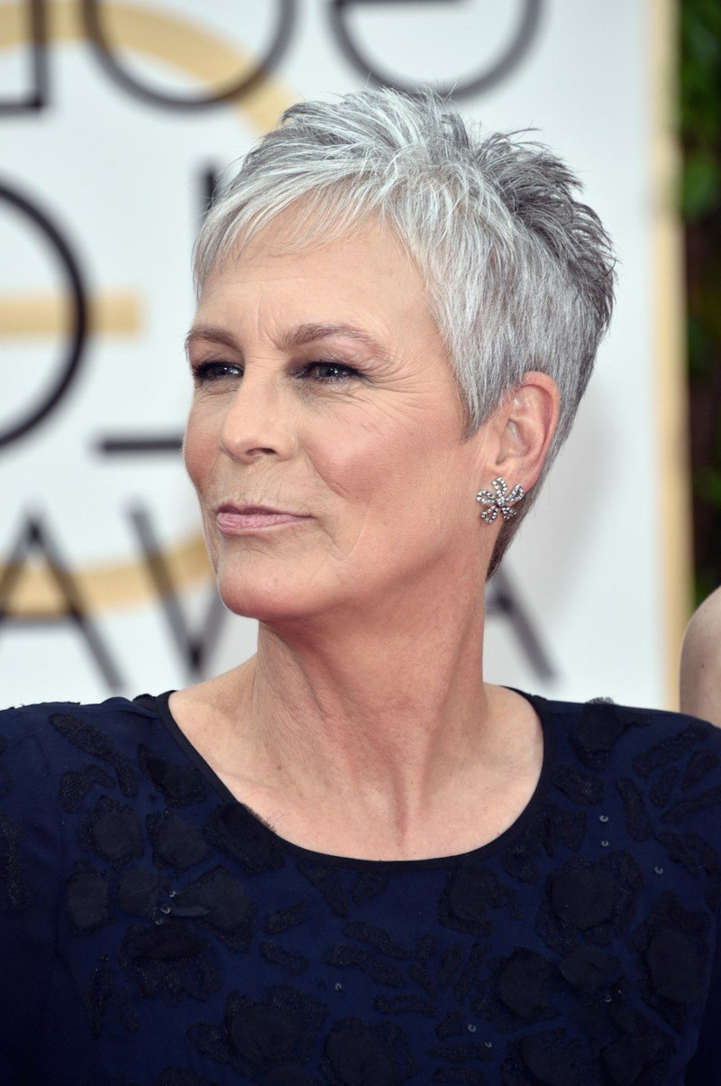short tapered haircut woman 60 years old gray pixie woman in black evening dress