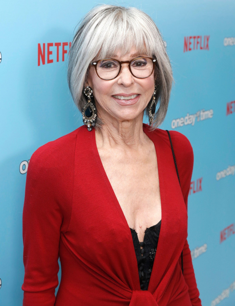 Short haircut for a 60-year-old woman with square gray glasses with bangs