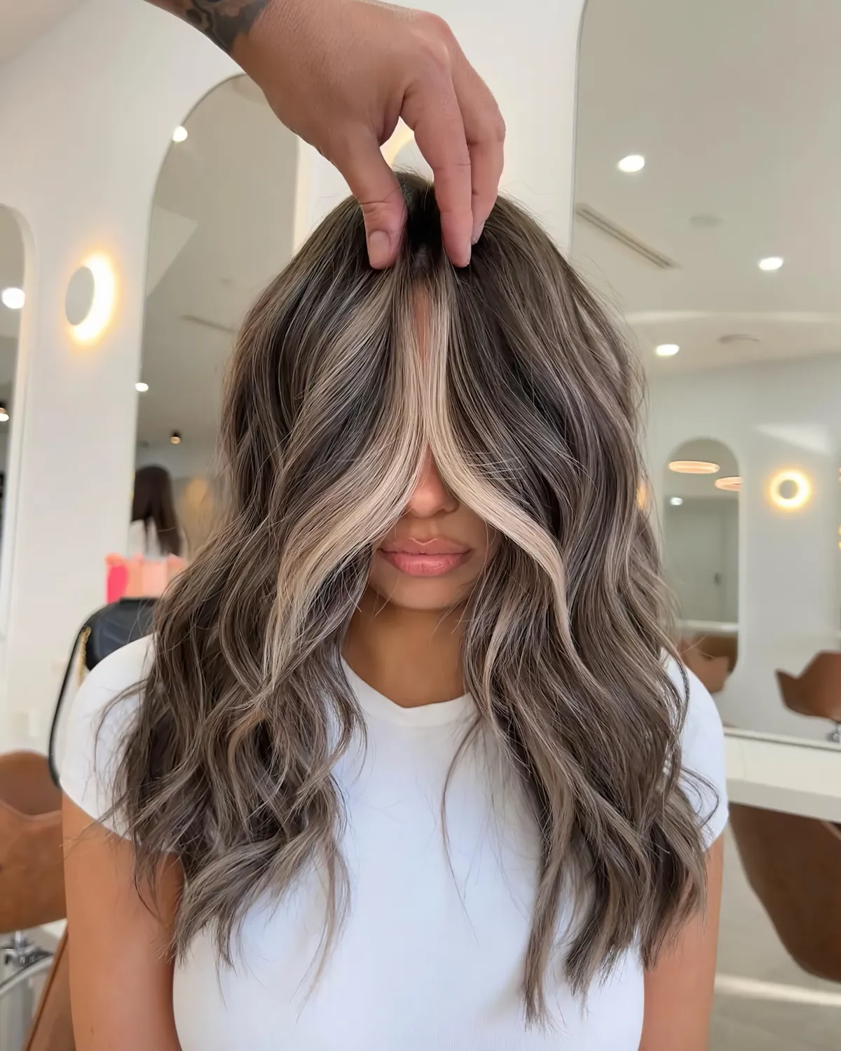 femme en t shirt blanc aux cheveux mi longs ondules balayage