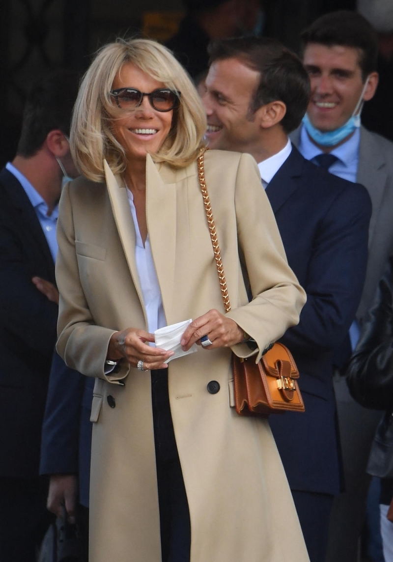 beige coat and sunglasses with long sixties woman look