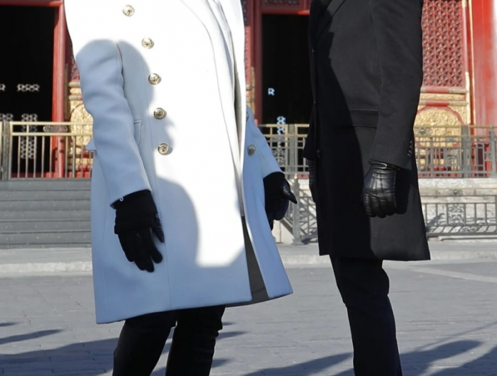 manteau blanc pantalon noir bottes noires tenue brigitte macron