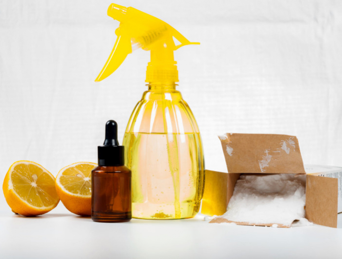 eco friendly natural cleaners made of lemon and baking soda on white wooden table