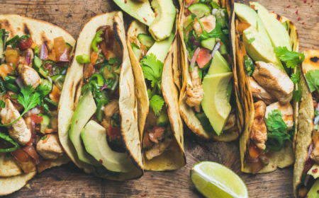 tacos with grilled chicken, avocado, fresh salsa sauce and limes