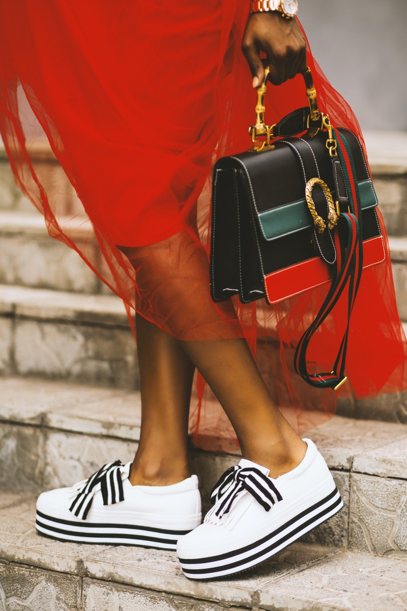 white sneakers red tutu skirt black handbag