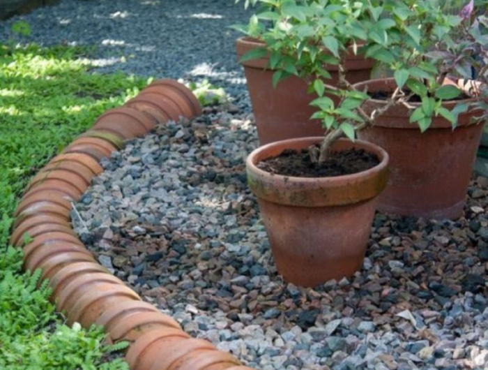 des pots terracota emboités les uns dans les autres pour faire contour maison jardin