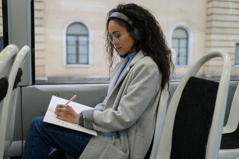 femme voyage bus jeans carnet crayon langage