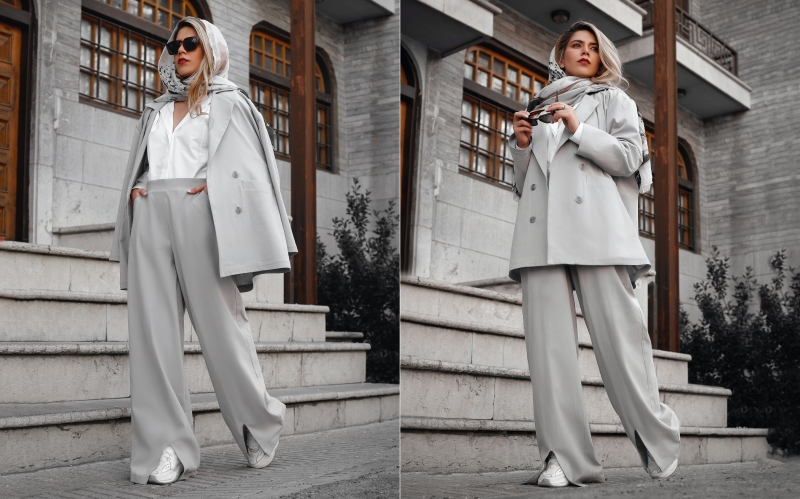 wearing sneakers at 50 with a chic light gray flowy pantsuit