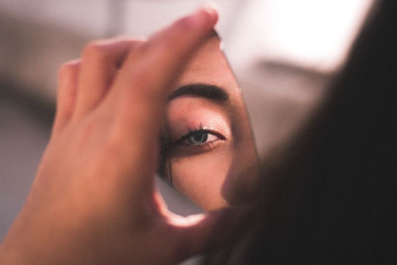 female eye in a piece of mirror