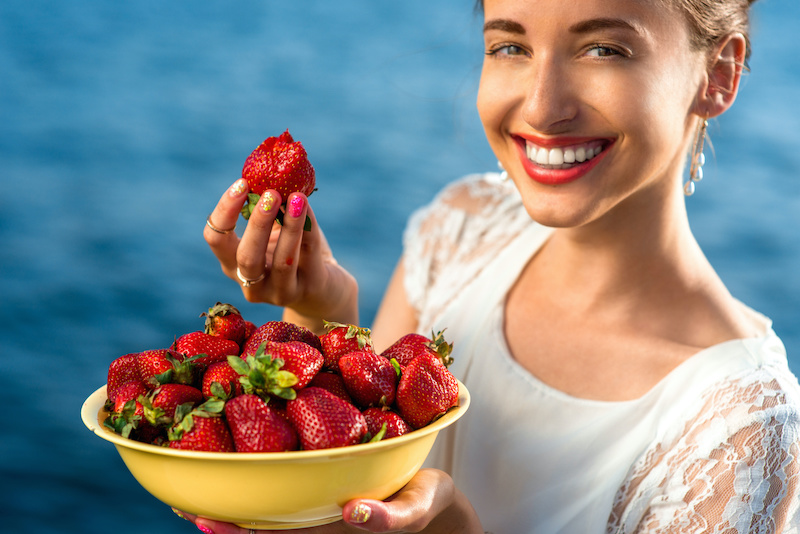 woman eating strawberry