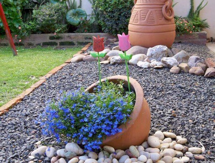 composition avec pou blue en fleur et des cailloux de differente taille