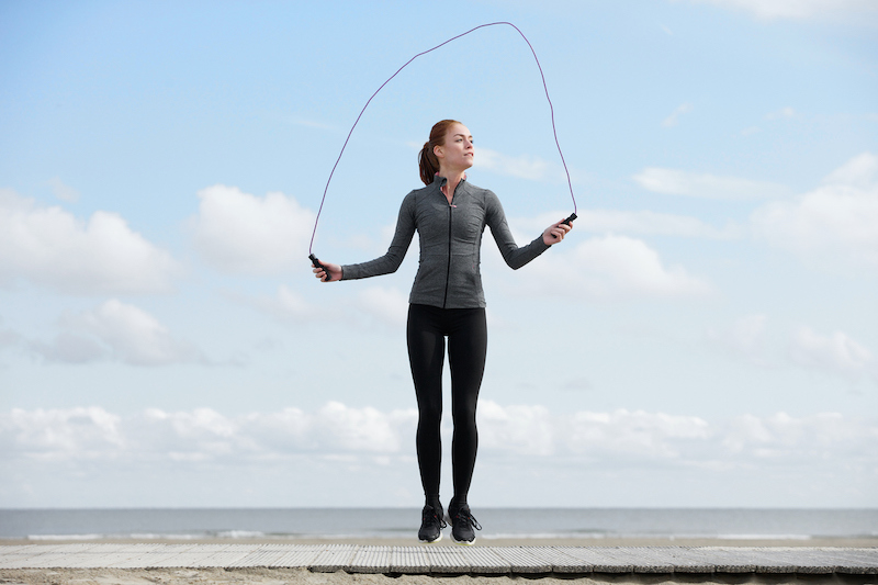 healthy young woman with jump rope