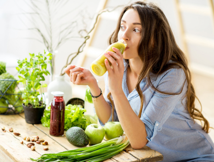 woman with green healthy food at home