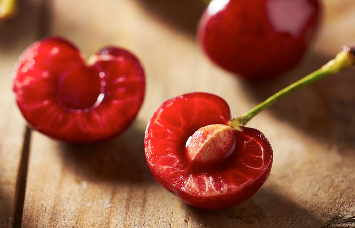 red,ripe,open,cherry,on,wooden,background