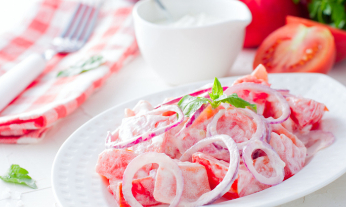 vegetarian salad with fresh red tomatoes and red onions, selective focus