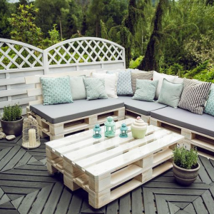 salon de jardin avec des palettes style scandinavien avec table basse et canape en boir rempli de ocussin beige