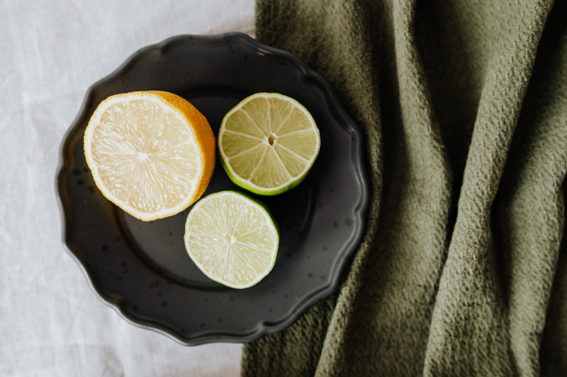 nettoyer vitre avec citron demi agrume assiette noire citorn vert