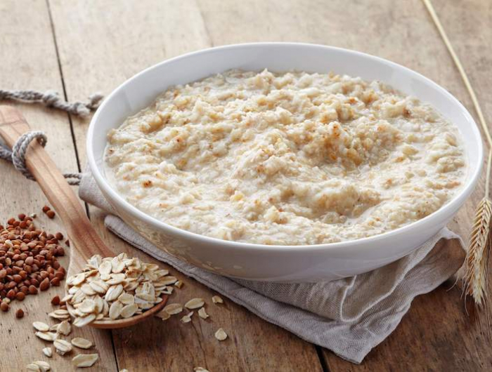 bowl of various flakes porridge on wooden table