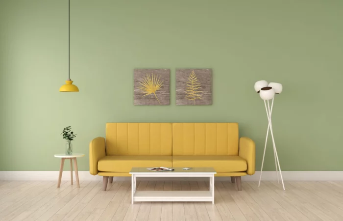 un salon avec un canape jaune et un mur vert sauge