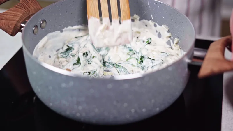 Melt cheese with sauteed spinach