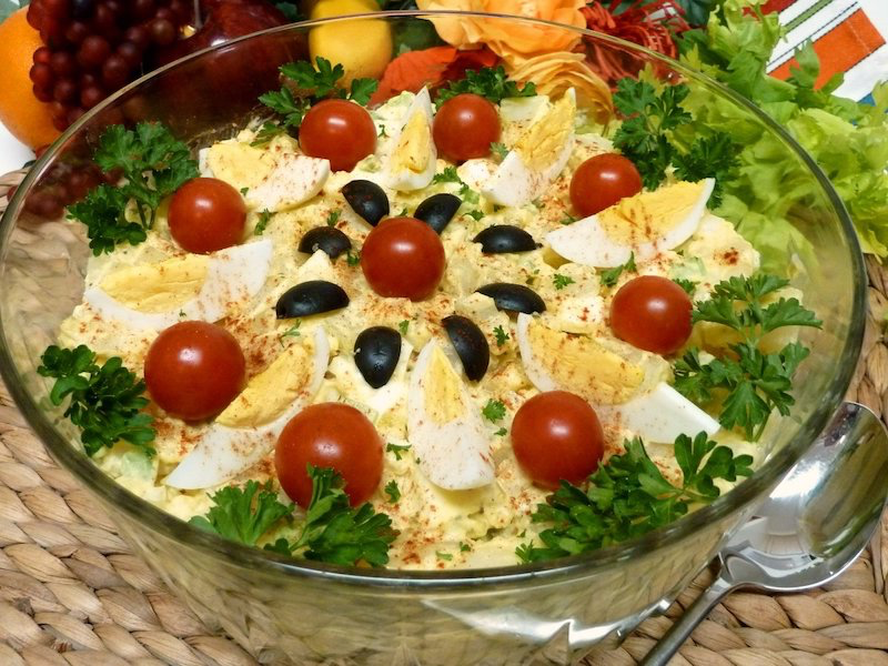 full plate salads with eggs and cheese in a glass bowl