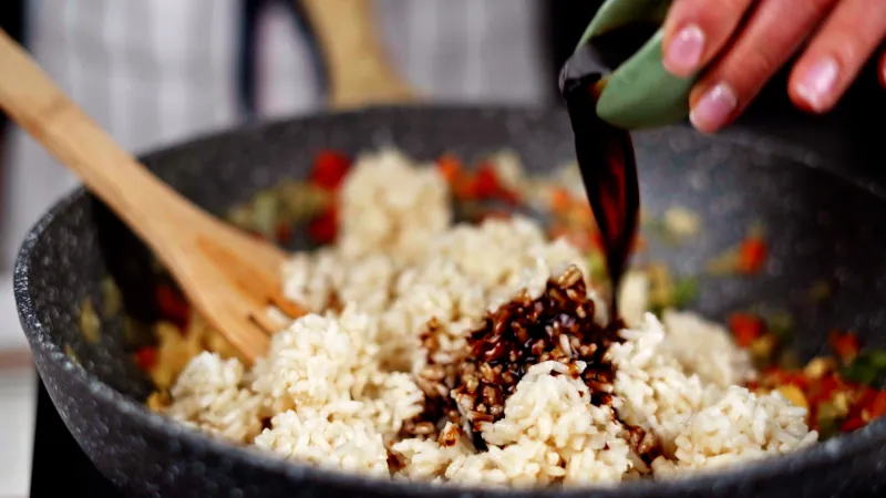 Pour soy sauce over rice and vegetables