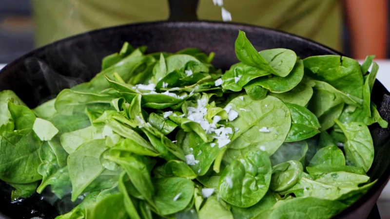 Spinach in a pan with salt