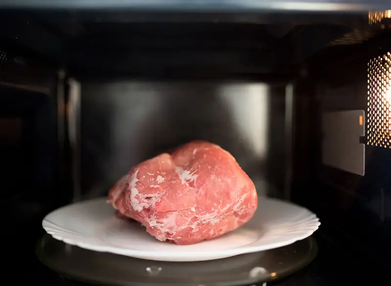 can you cook frozen meat in the microwave